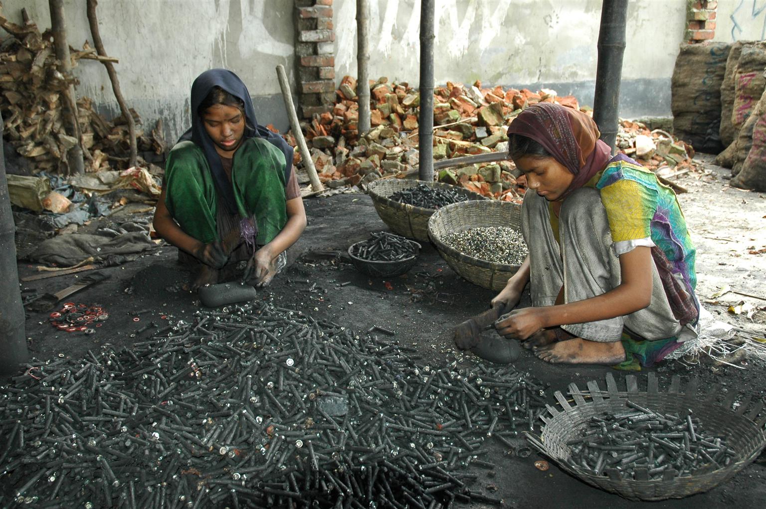 Young girls separate e-waste without protection
