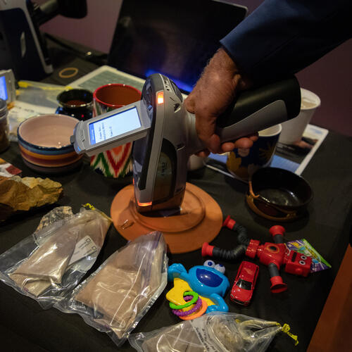 © UNICEF/UNI649316/Licht Person uses XRF tool to assess lead in products on a table